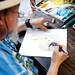 North Carolina resident John Furches creates a print behind his gallery tent during the Ann Arbor Art Fair on South University Avenue on Saturday, July 20. This is his second year participating. Daniel Brenner I AnnArbor.com